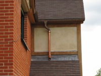 Downpipe above porch roof